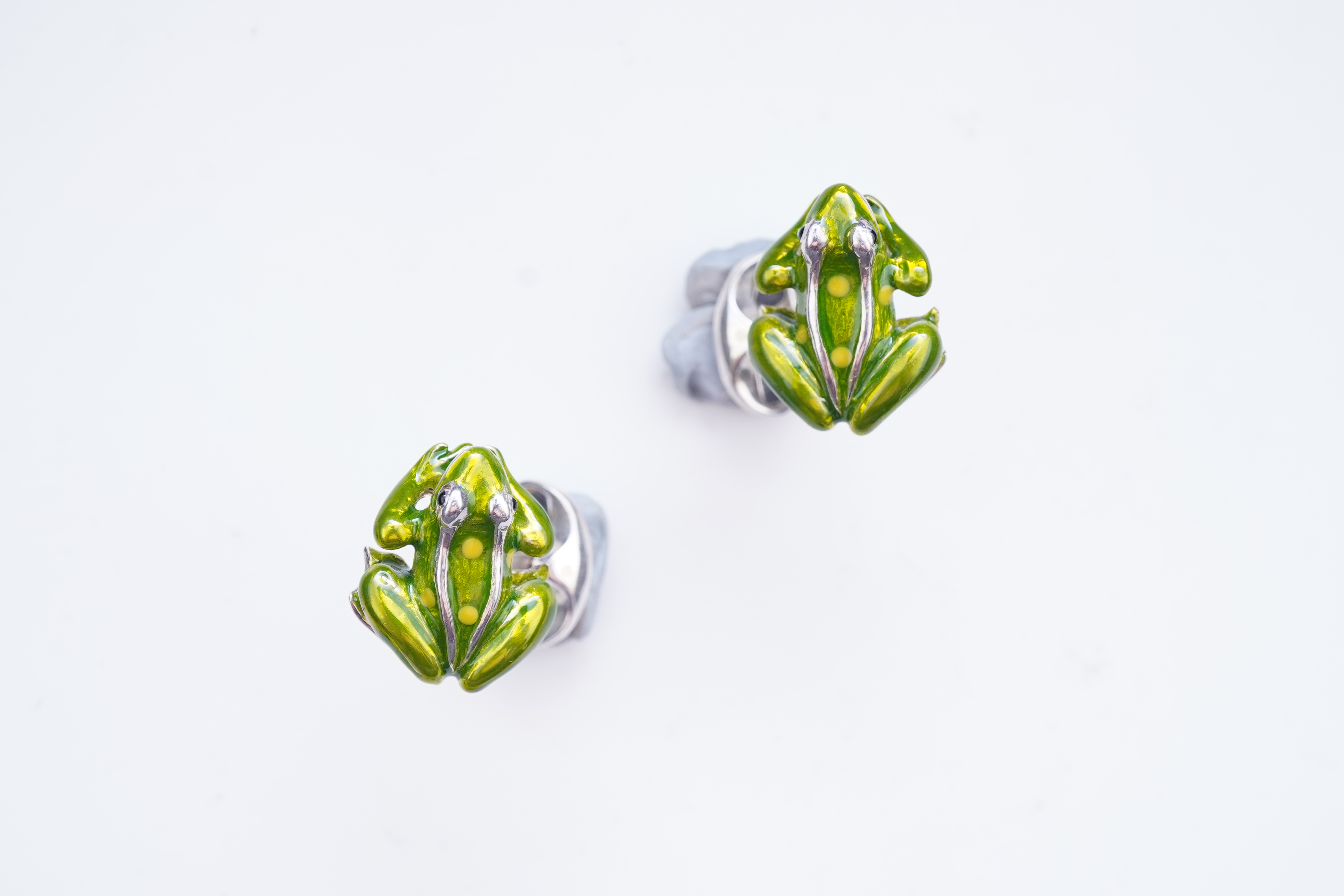 A modern pair of silver and polychrome enamel set oval cufflinks, 18mm.